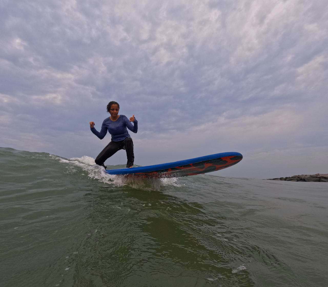 Surfer paddling toward a clean breaking wave